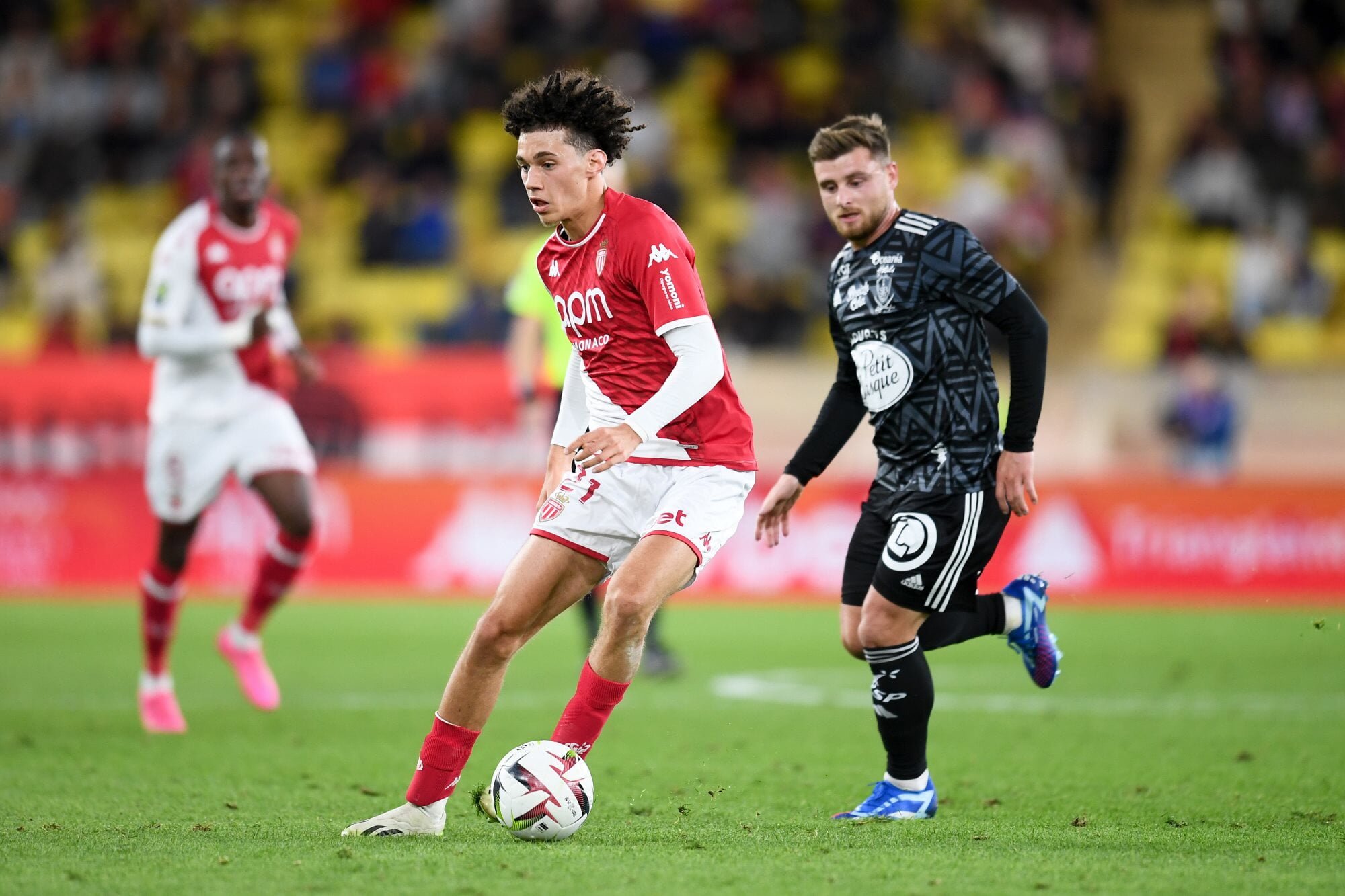 AS Monaco's Maghnes Akliouche and Stade Brestois' Hugo Magnetti battle for the ball