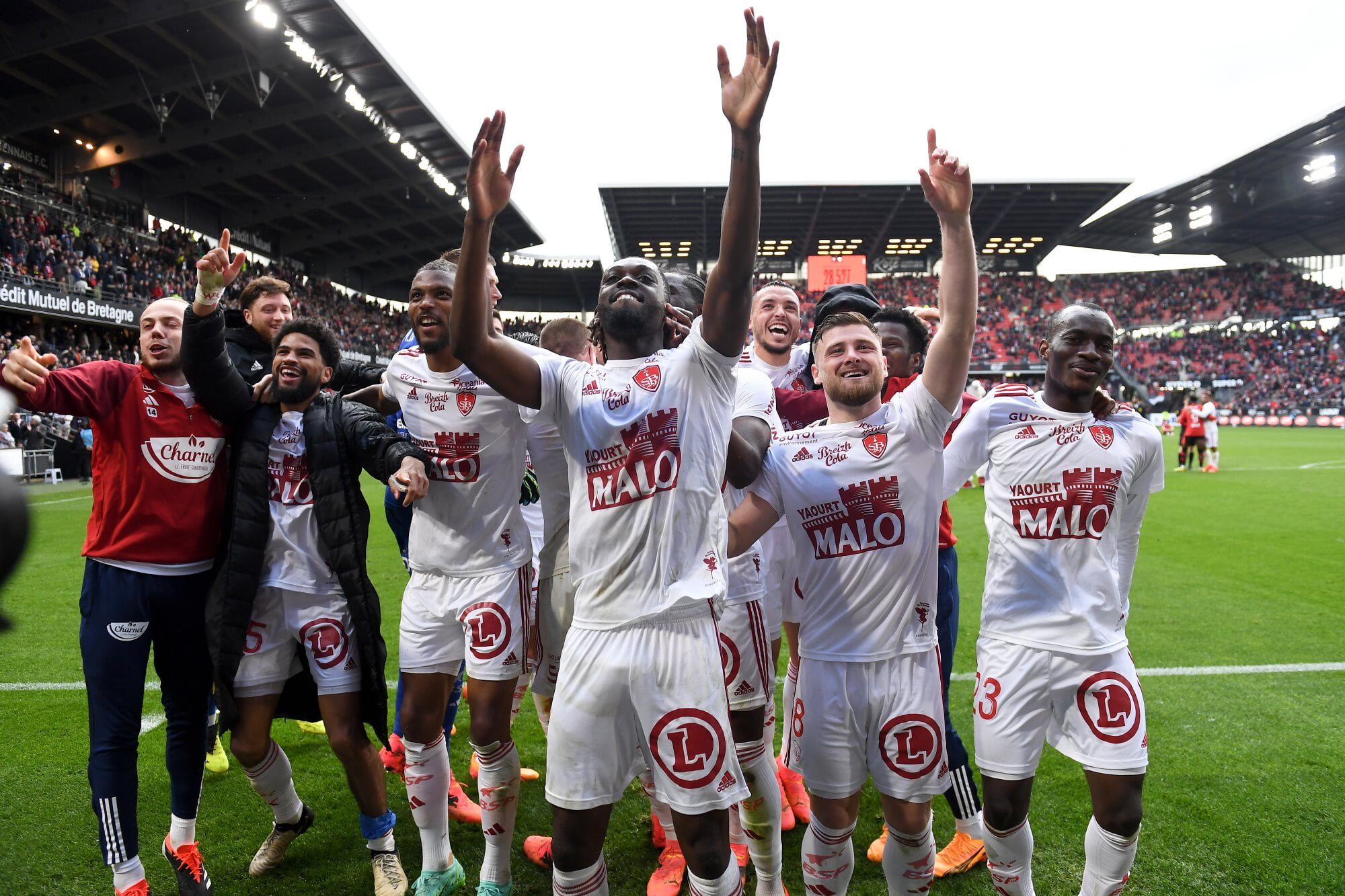 Stade Brestois players celebrate a win away to Stade Rennais
