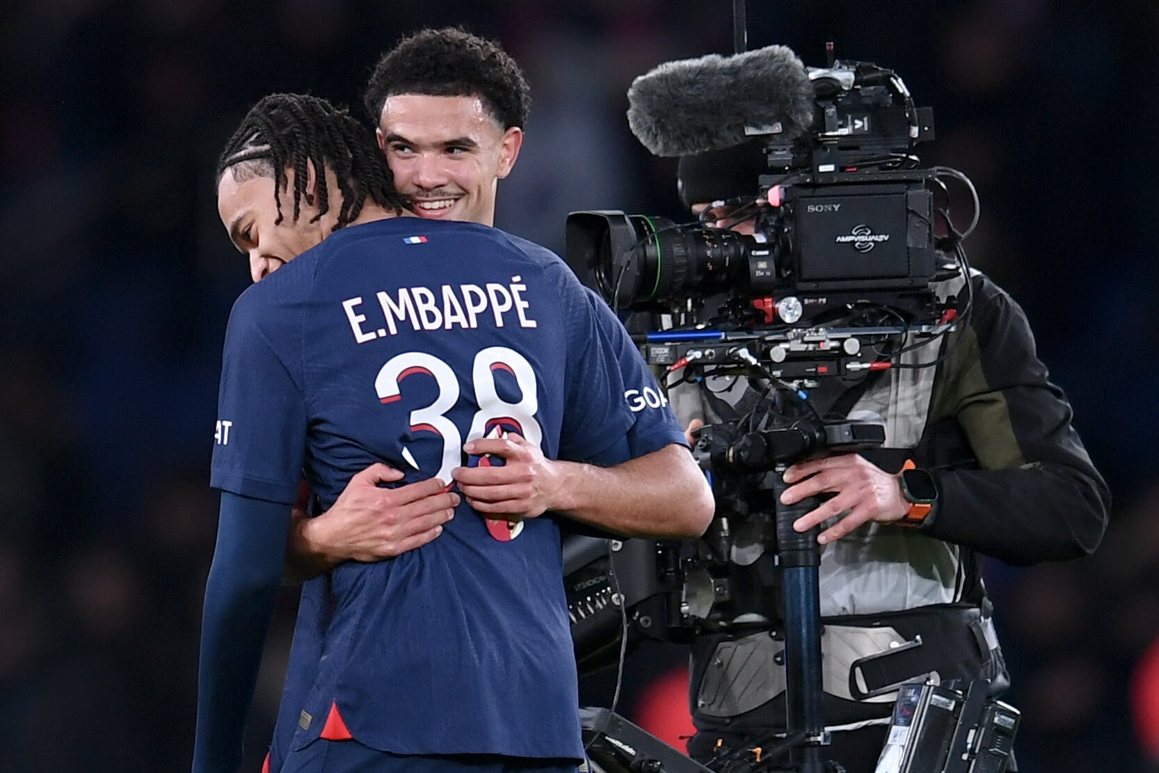 Paris Saint-Germain's Warren Zaïre-Emery and Ethan Mbappé embrace